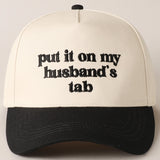 Put It On My Husband's Tab Trucker Cap | Black